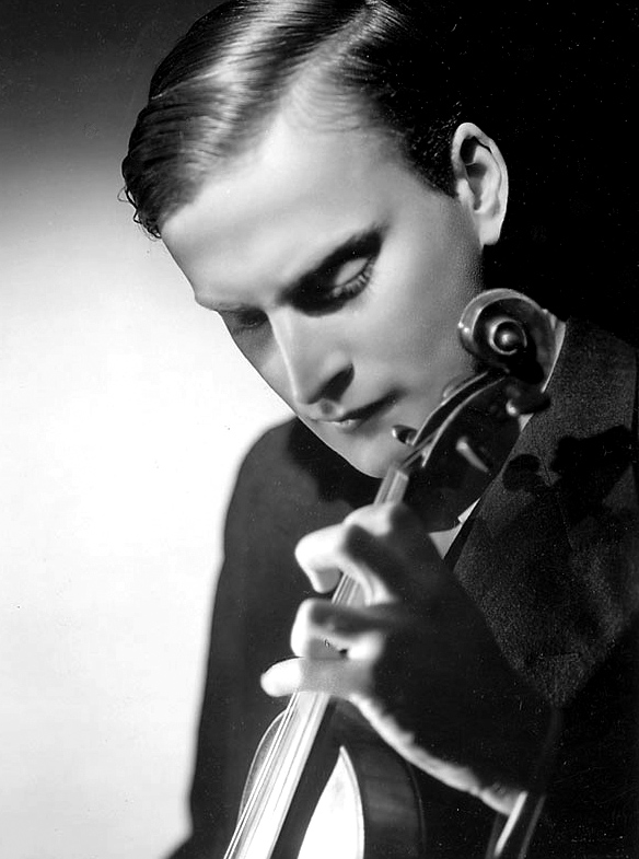 Close-up black and white photo of a young man playing the violin.